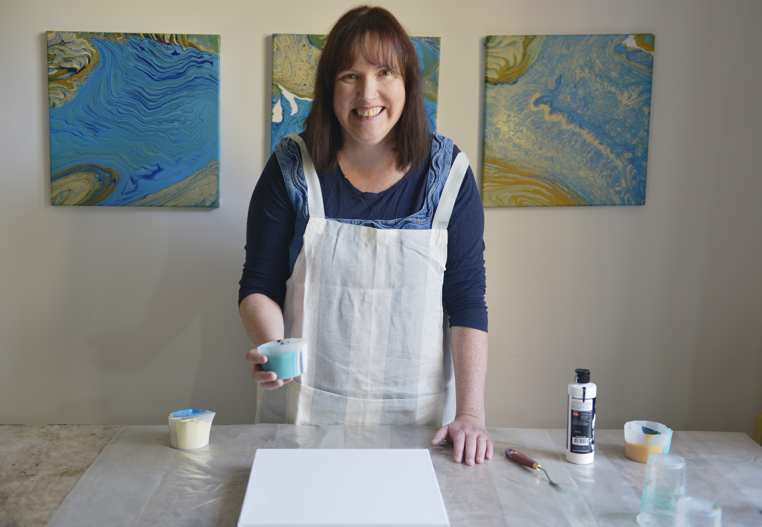 Easels and painting supplies in a warm art workshop